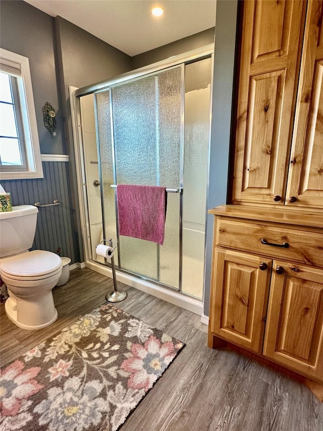 415 Galena Rd, Philipsburg, MT 59858 - bathroom featuring a wainscoted wall, toilet, baseboards, wood finished floors, and a shower stall