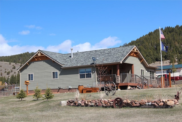 415 Galena Rd, Philipsburg, MT 59858 - back of house with a shingled roof, a yard, a mountain view, and fence