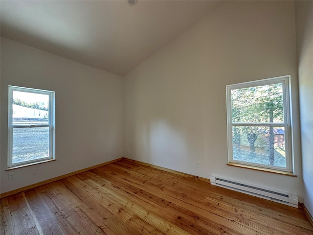 519 Grizzly Dr, Thompson Falls, MT 59873 - unfurnished room featuring baseboards, a baseboard radiator, wood finished floors, and lofted ceiling