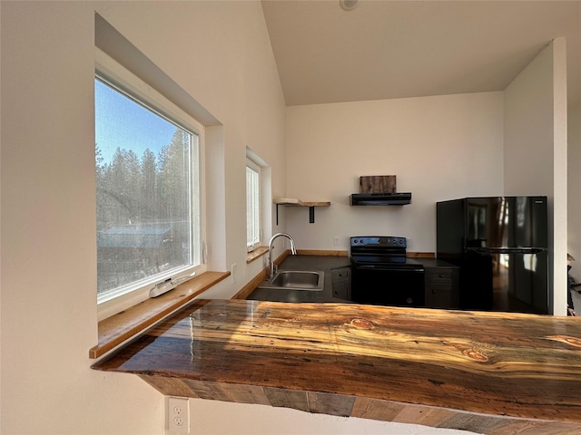 519 Grizzly Dr, Thompson Falls, MT 59873 - kitchen with range hood, a sink, vaulted ceiling, and black appliances