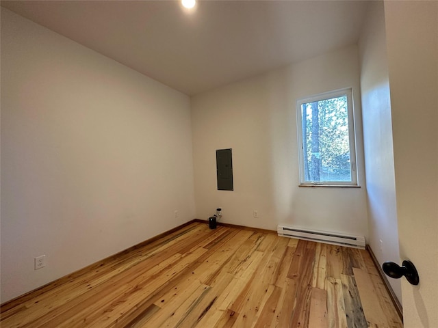 519 Grizzly Dr, Thompson Falls, MT 59873 - empty room with light wood finished floors, a baseboard heating unit, baseboards, and electric panel