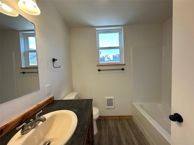 519 Grizzly Dr, Thompson Falls, MT 59873 - bathroom featuring toilet, a wealth of natural light, wood finished floors, and vanity