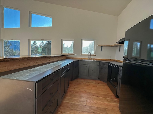 519 Grizzly Dr, Thompson Falls, MT 59873 - kitchen featuring a healthy amount of sunlight, a sink, open shelves, and black appliances