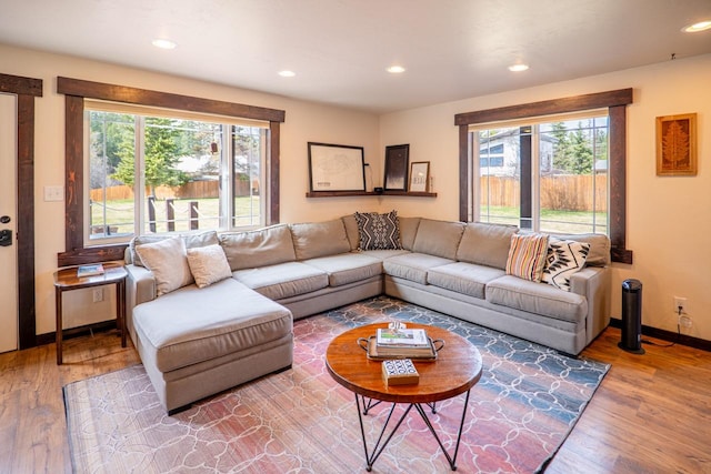 living area with wood finished floors, baseboards, plenty of natural light, and recessed lighting