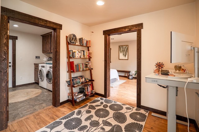 hallway with recessed lighting, washing machine and dryer, baseboards, and light wood-style flooring
