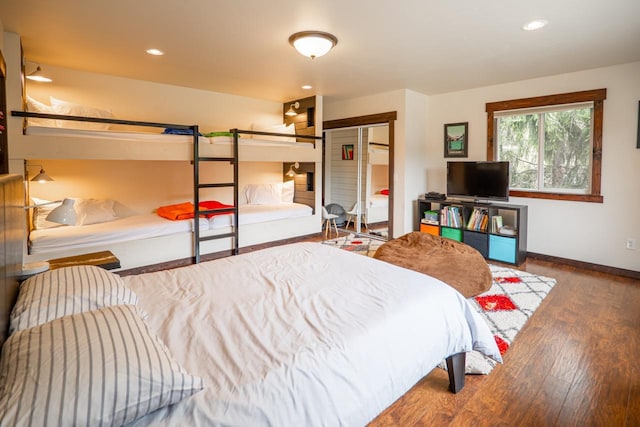 bedroom featuring baseboards, recessed lighting, and wood finished floors