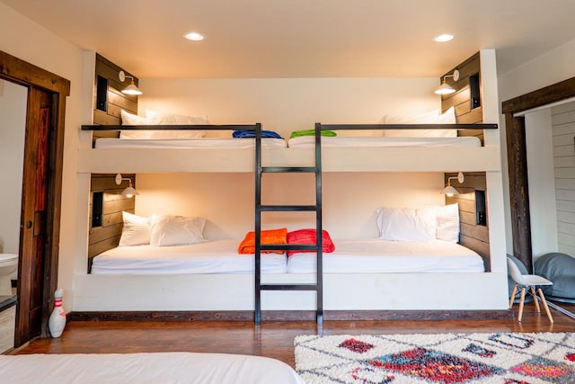 bedroom with baseboards, recessed lighting, and wood finished floors