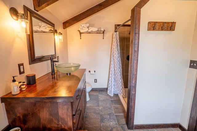 bathroom with a shower stall, vanity, stone finish flooring, and lofted ceiling with beams