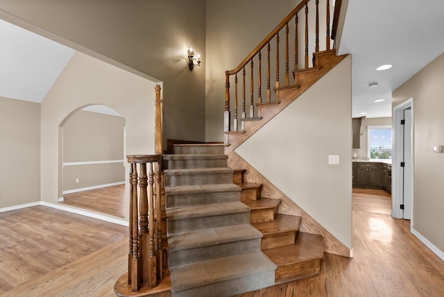 344 Stillwater Loop, Kalispell, MT 59901 - stairs with wood finished floors, arched walkways, and recessed lighting