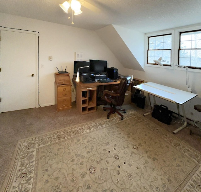 carpeted office featuring a textured ceiling and a ceiling fan