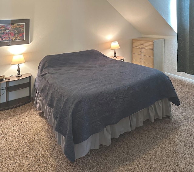 bedroom with light colored carpet and lofted ceiling