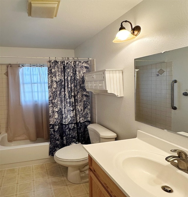 full bath with tile patterned floors, shower / tub combo with curtain, vanity, and toilet