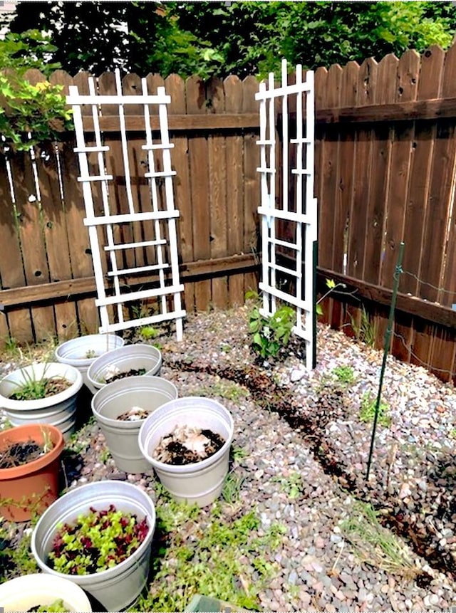 view of yard with fence and a vegetable garden