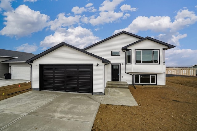 split level home featuring an attached garage and driveway
