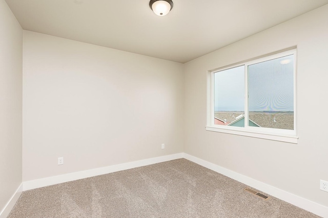 spare room featuring visible vents, baseboards, and carpet floors