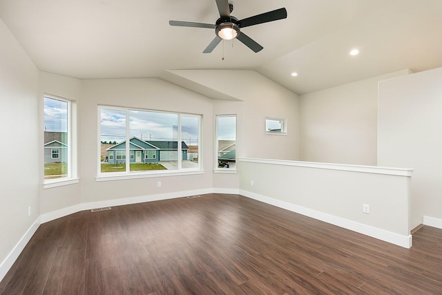 empty room featuring visible vents, baseboards, a ceiling fan, dark wood finished floors, and lofted ceiling