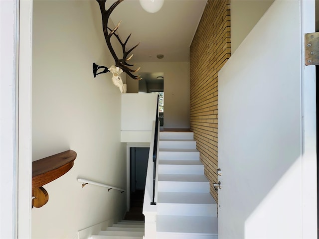 767 33rd Ave NE, Great Falls, MT 59404 - stairway with an accent wall and brick wall