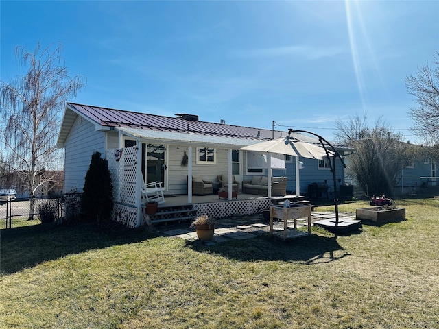 767 33rd Ave NE, Great Falls, MT 59404 - back of property with an outdoor hangout area, a metal roof, and a standing seam roof