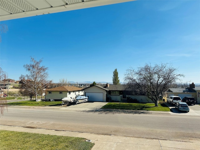 767 33rd Ave NE, Great Falls, MT 59404 - view of front facade with driveway, a residential view, an attached garage, and a front lawn
