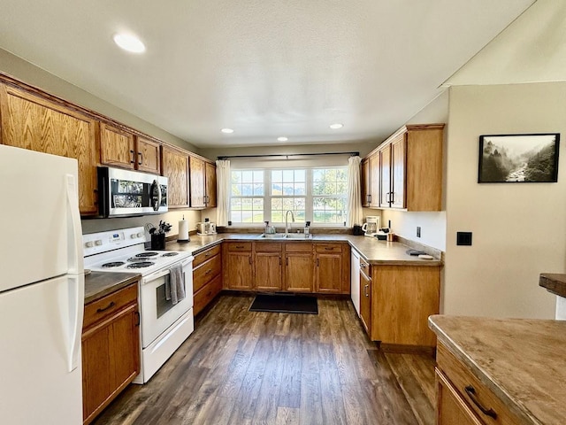 992 Trumble Creek Rd, Kalispell, MT 59901 - kitchen with white appliances, brown cabinetry, dark wood-type flooring, and recessed lighting