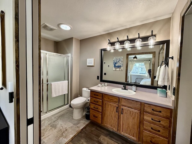992 Trumble Creek Rd, Kalispell, MT 59901 - bathroom featuring a stall shower, vanity, a textured ceiling, and connected bathroom