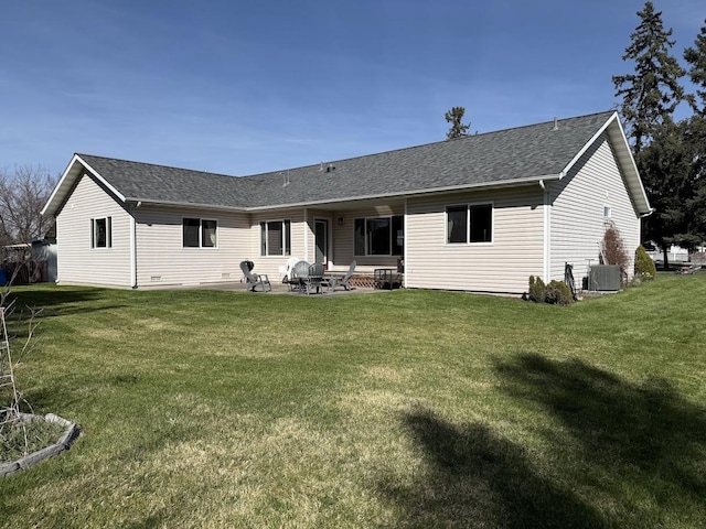 992 Trumble Creek Rd, Kalispell, MT 59901 - rear view of house featuring a lawn, a patio, and roof with shingles