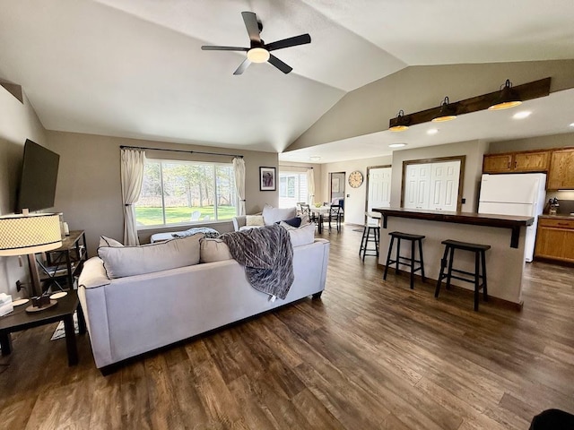 992 Trumble Creek Rd, Kalispell, MT 59901 - living area with lofted ceiling, a ceiling fan, and dark wood-type flooring