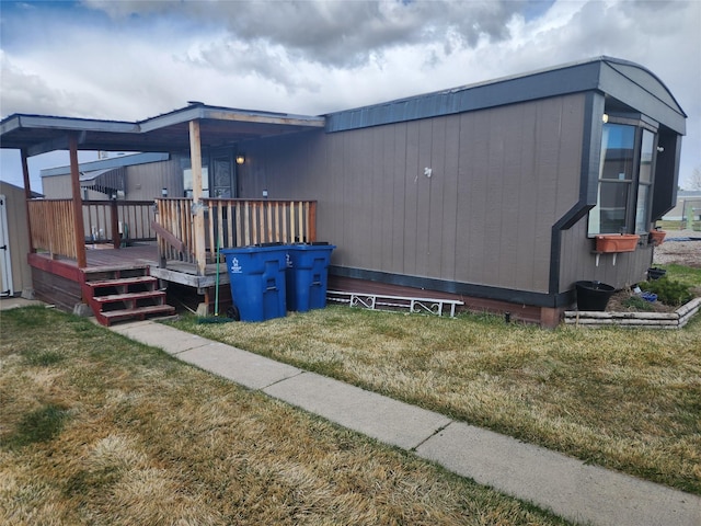 3805 7th St NE Unit 26, Great Falls, MT 59404 - view of side of home with a yard and a deck