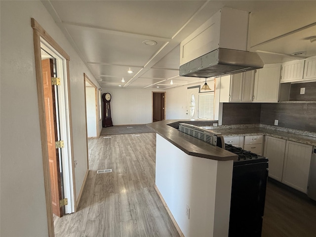 3805 7th St NE Unit 26, Great Falls, MT 59404 - kitchen with visible vents, open floor plan, dark countertops, wood finished floors, and extractor fan