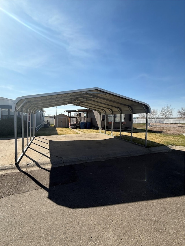 3805 7th St NE Unit 26, Great Falls, MT 59404 - view of vehicle parking featuring a detached carport and a storage shed