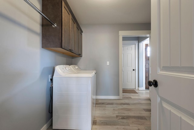 2240 Kenai Rd, Helena, MT 59602 - washroom with light wood-style floors, separate washer and dryer, baseboards, and cabinet space