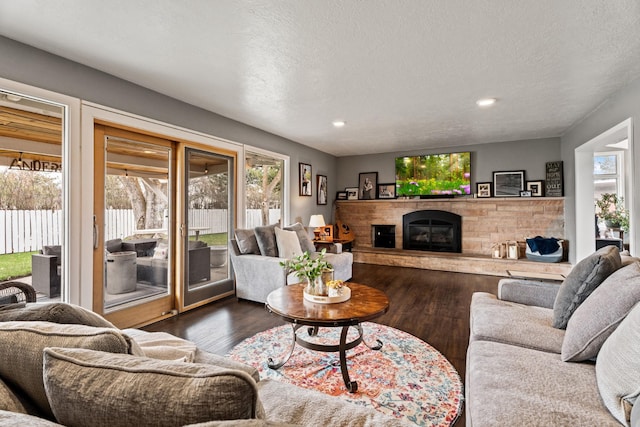 2324 Cloverdale Dr, Missoula, MT 59803 - living room with dark wood-style flooring, a fireplace, recessed lighting, and a textured ceiling