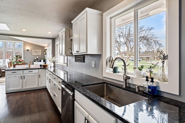 2324 Cloverdale Dr, Missoula, MT 59803 - kitchen featuring dishwasher, a peninsula, white cabinets, dark stone countertops, and lofted ceiling