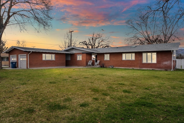2324 Cloverdale Dr, Missoula, MT 59803 - view of front facade featuring brick siding, an attached garage, and a patio area