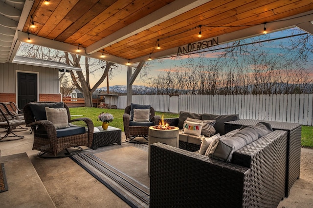 2324 Cloverdale Dr, Missoula, MT 59803 - patio terrace at dusk with an outdoor living space with a fire pit, a patio area, and a fenced backyard