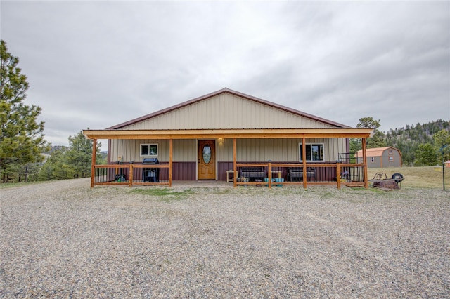 country-style home featuring board and batten siding and an outbuilding