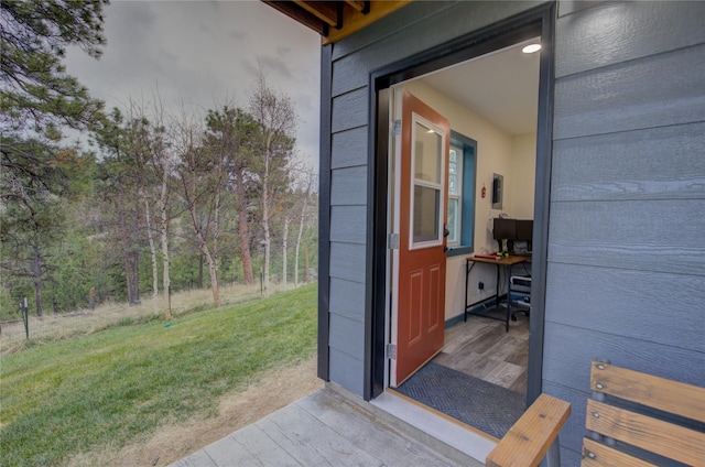 entrance to property featuring a yard
