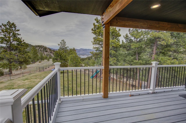 deck featuring a yard and a mountain view