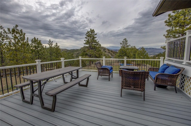 wooden deck featuring an outdoor living space and a mountain view
