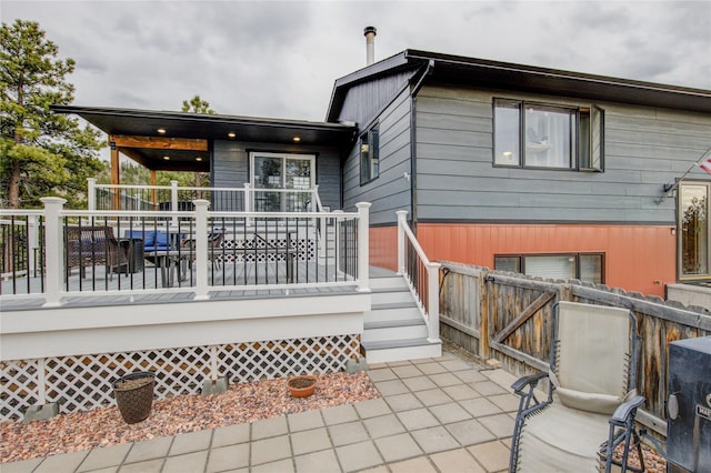 back of house with fence and a deck