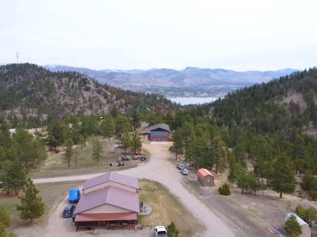 drone / aerial view featuring a view of trees and a mountain view