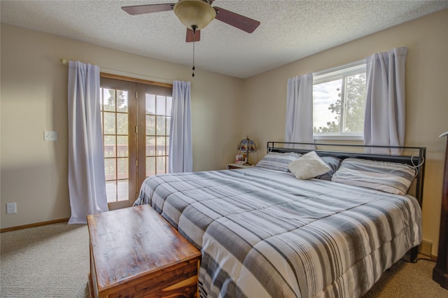 bedroom featuring carpet, multiple windows, a textured ceiling, and ceiling fan
