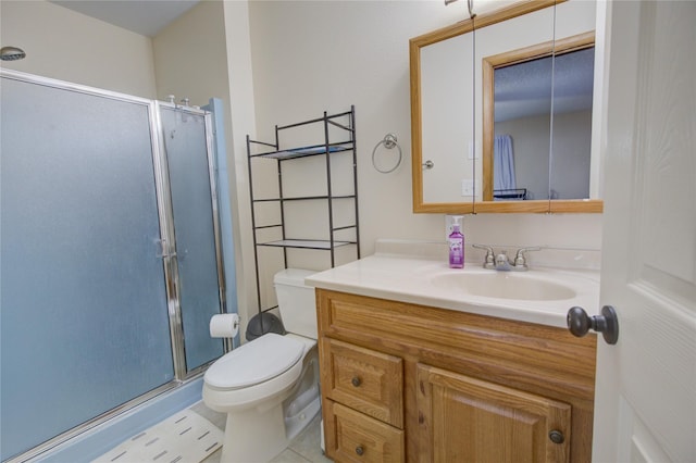 full bathroom with a shower stall, tile patterned flooring, vanity, and toilet