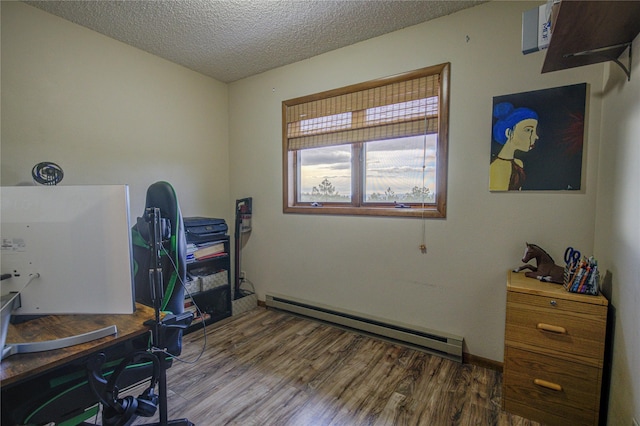 office area with a textured ceiling, wood finished floors, and baseboard heating