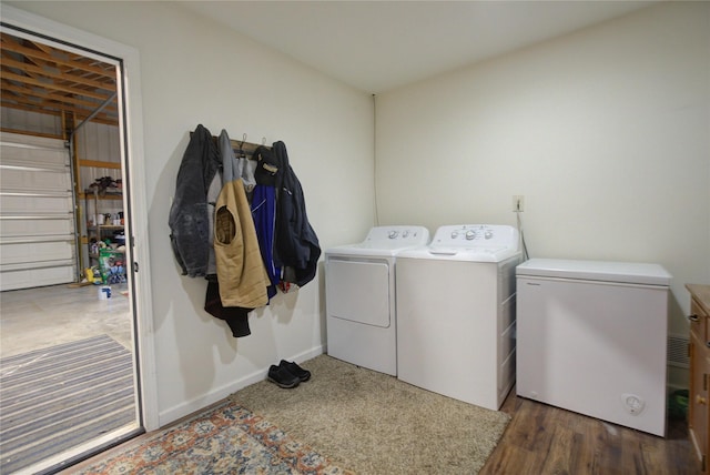 laundry area featuring baseboards, wood finished floors, washer and dryer, and laundry area
