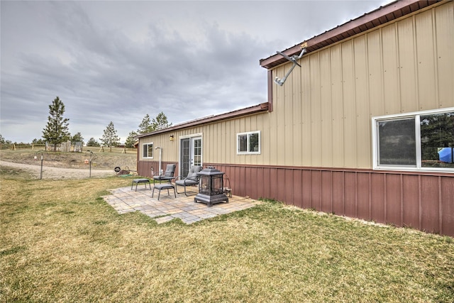back of property with a patio and a lawn