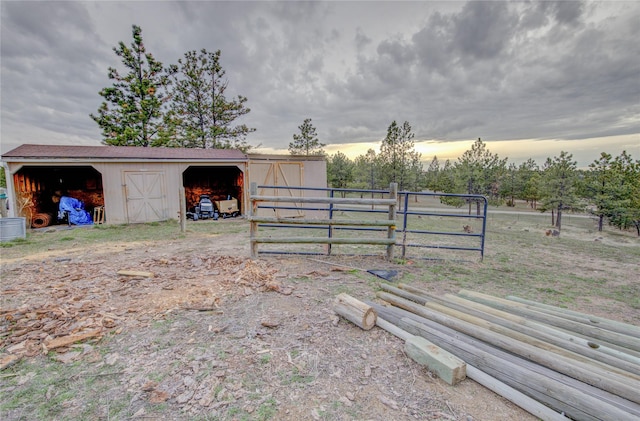 exterior space with an outbuilding, fence, and an outdoor structure