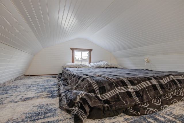 bedroom with carpet and lofted ceiling