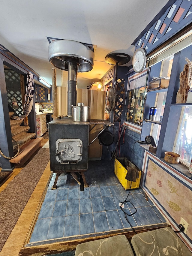 64 Ponderosa Ln, Thompson Falls, MT 59873 - tiled living area featuring a wood stove and stairway