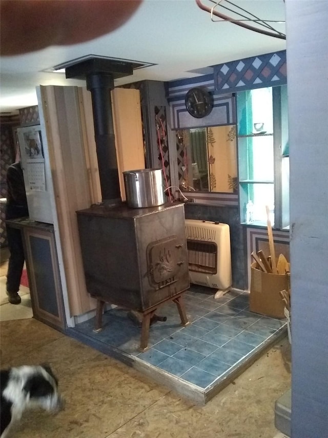 64 Ponderosa Ln, Thompson Falls, MT 59873 - living area featuring heating unit and a wood stove